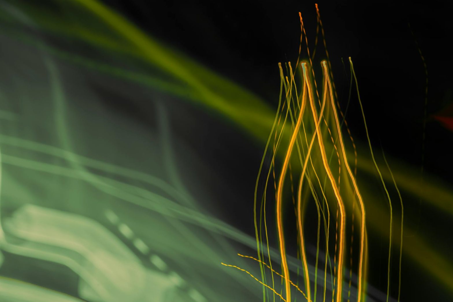 Vibrant abstract image capturing dynamic light trails in a long exposure shot, creating a sense of motion.